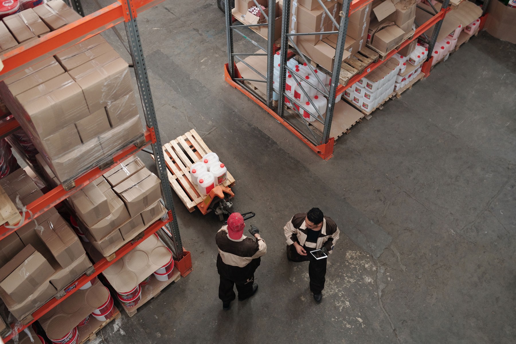 Warehouse employees checking goods and coordinating their work